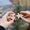 hands holding puzzle pieces